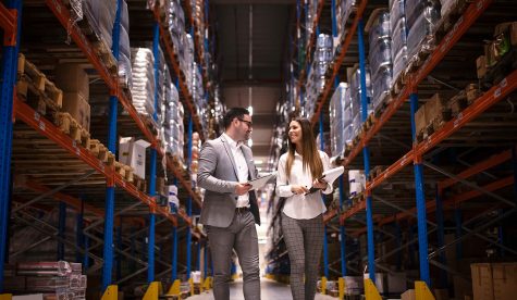 business-people-walking-through-large-distribution-center-talking-about-increasing-production-organization (1)